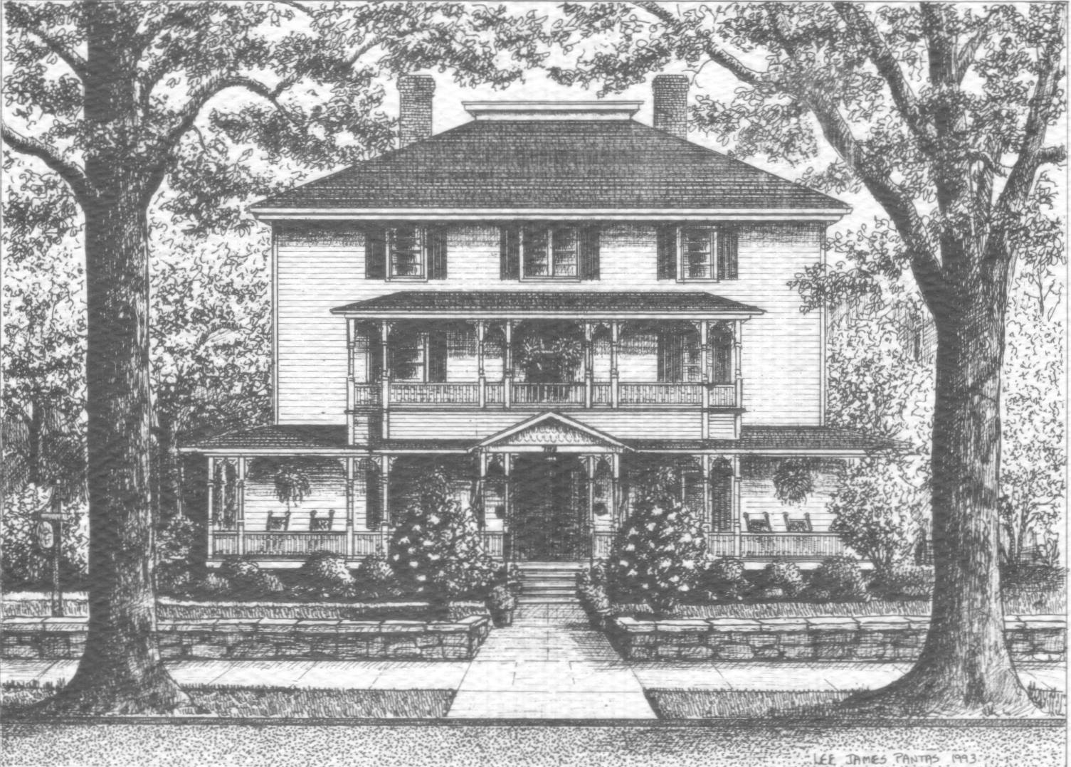 Black and white photo of out three story inn with front porch, front balcony, walkway, and twin trees framing the sides.