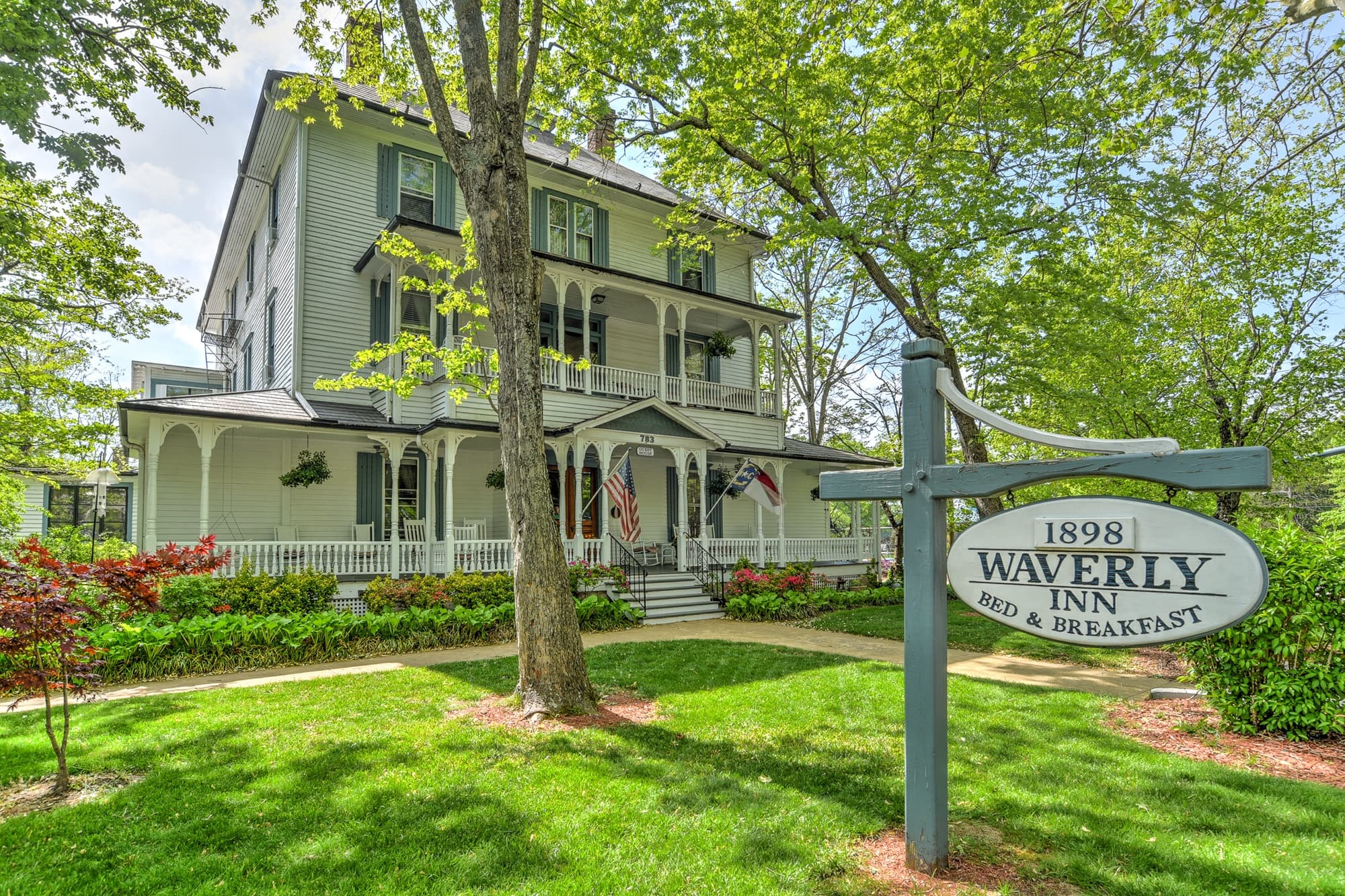 A historic bed and breakfast, Waverly Inn, surrounded by lush greenery.