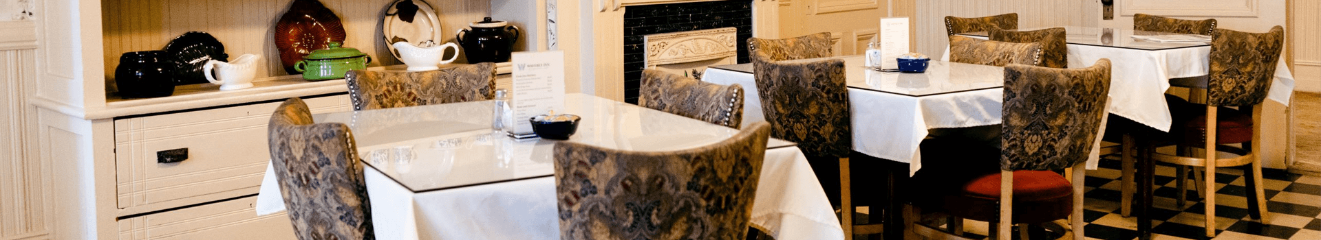 A charming dining area featuring elegant tables and patterned chairs.